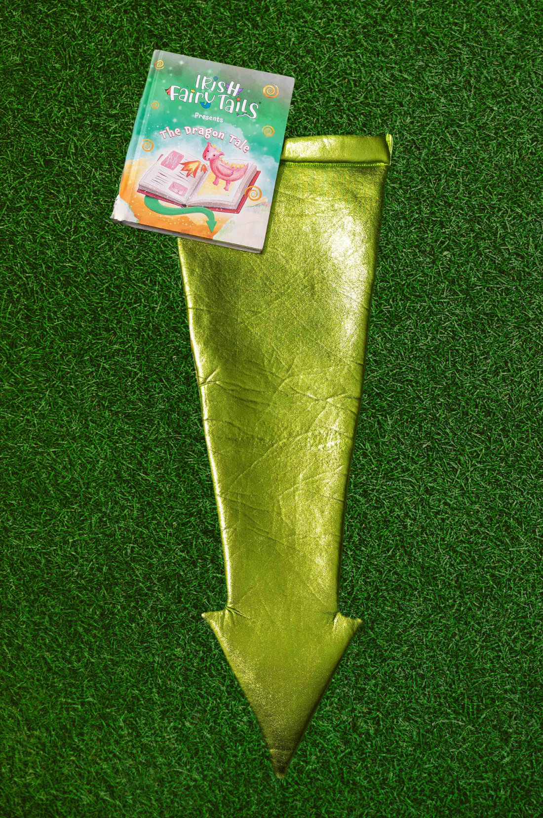 Green dragon tail costume with a book titled &
